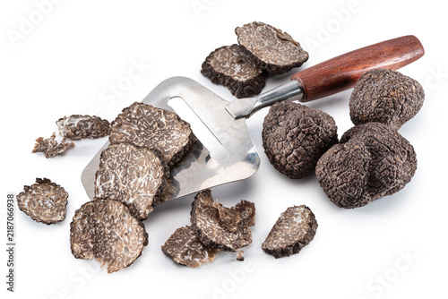 Fotografie Whole black truffles tuber and sliced truffle pieces with stainless steel slicer knife, with clipping path