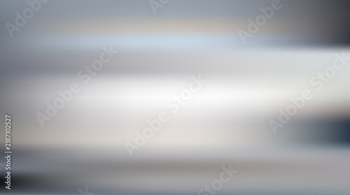 Abstract grey motion blur background with soft horizontal light streaks for modern design.