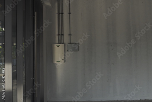 Exposed Electrical Utility Systems On Concrete Industrial Wall