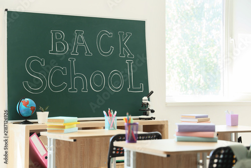 Back to school education concept, classroom interior with chalkboard and supp...