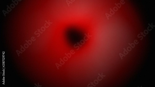 Abstract red light tunnel vortex expanding in darkness