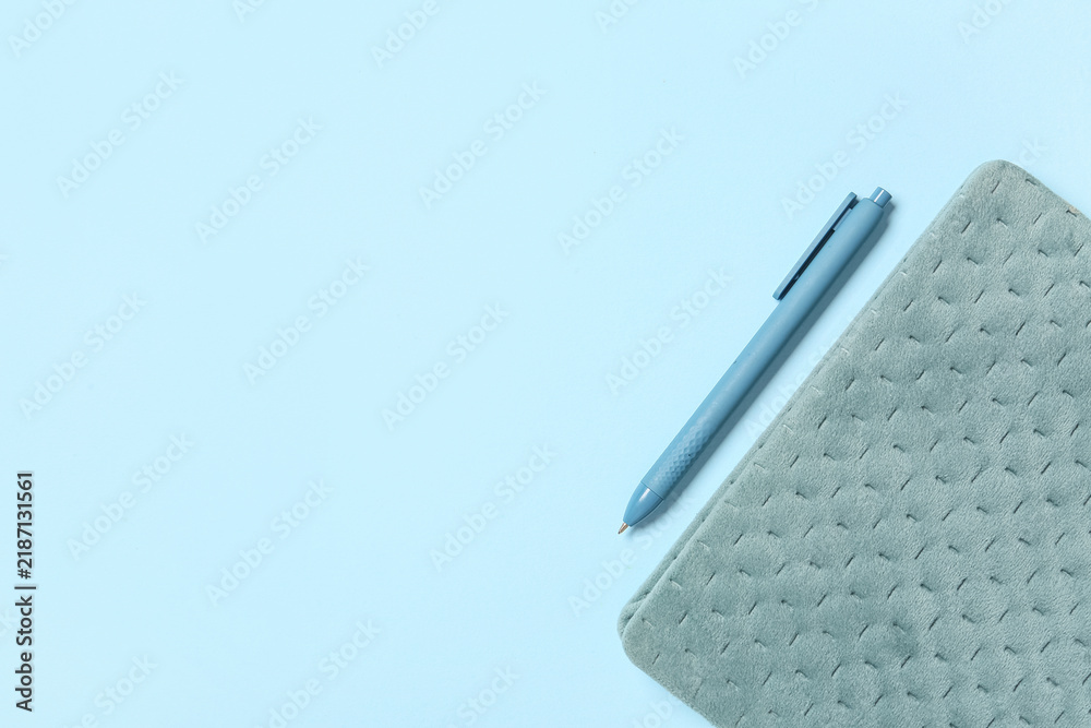 Obraz premium Planning and productivity concept, blue pen and textured notebook on a light blue background for business organization and creative writing tasks