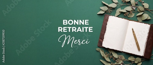 French retirement card Bonne Retraite Merci text with open journal, fountain pen, and eucalyptus leaves on green background for elegant farewell greeting card design and celebration message banner.