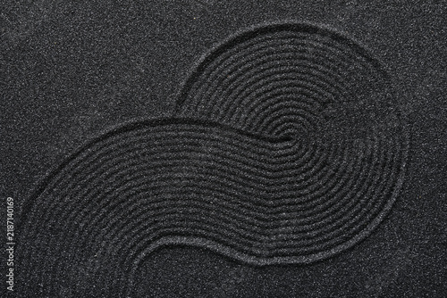 Bild auf Leinwand Mindfulness and zen meditation, raked black sand pattern with flowing curves for