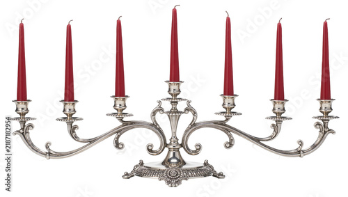 Fotografie Ornate silver candelabra holding seven red taper candles, isolated on transparen