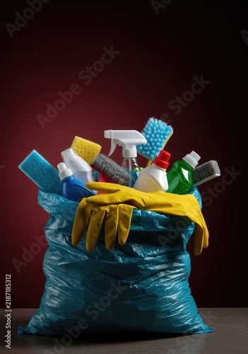 Household cleaning supplies being crammed into a disposal sack, symbolizing the end of boring daily chores and tasks and newfound relief ,chores ,tools ,responsibility