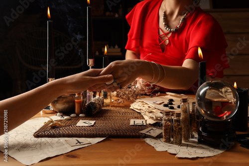 Obraz na płótnie Fortune teller reading womans palm at table