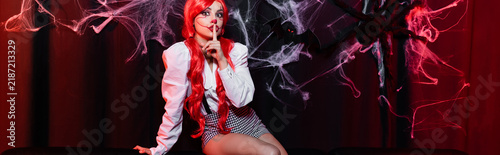 фотографія Creepy clown girl cosplay for Halloween with bright red hair and playful spirit,