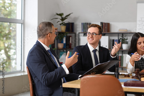 Male lawyers working at table in office
