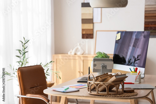 Graphic designers workplace with computer and books in office