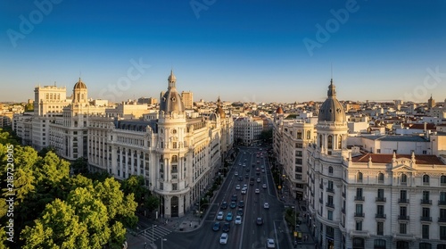 Historic Gran Via street in Madrid, Spain, captured in a panoramic aerial view during warm sunset light