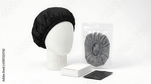 Black shower cap for hair protection and beauty, presented with packaging