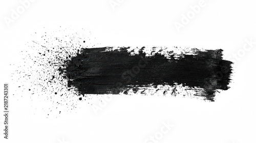 Thick black paint brush stroke with powder splatter isolated on transparent background