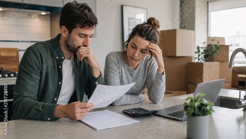 Young American couple reviewing increased apartment rent