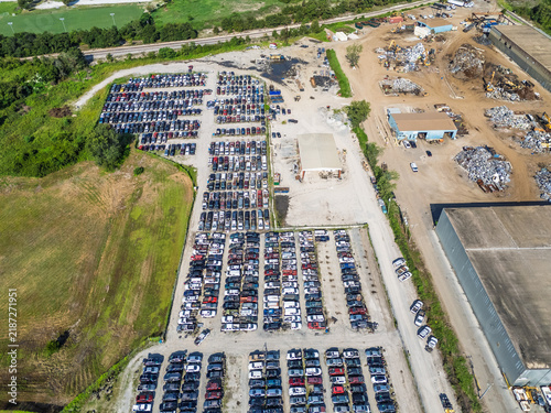 Aerial view of Cape Fear Pick N Pull salvage yard featuring rows of parked cars, scrap metal piles, and industrial buildings in Wilmington, North Carolina, United States.
