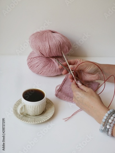 Obraz na płótnie Close-up of woman's hands holding circular knitting needles with pink wool swatc