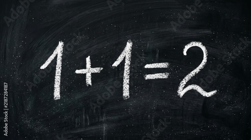 Handwritten simple addition equation 1+1=2 on a chalkboard.