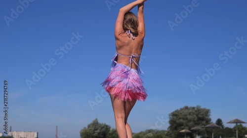 Beautiful Tanned Woman Posing On River Beach In Summer Dress. Dancing And Relaxing During A Sunny Vacation.