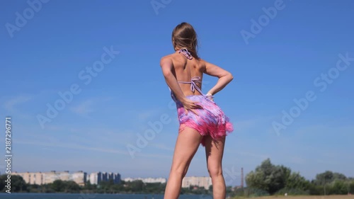 Tanned Young Woman Enjoying A Relaxing Summer Day On The Riverside. Dancing And Taking A Break From Everyday Life.