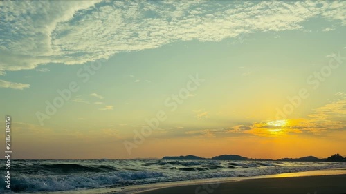 Calming ocean wave ripples on the beach at golden hour
