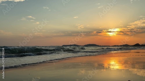 Calming ocean wave ripples on the beach at golden hour
