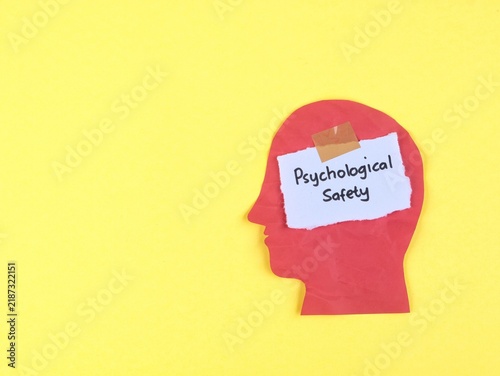 Foto Psychological safety phrase on paper taped to red head silhouette on yellow background