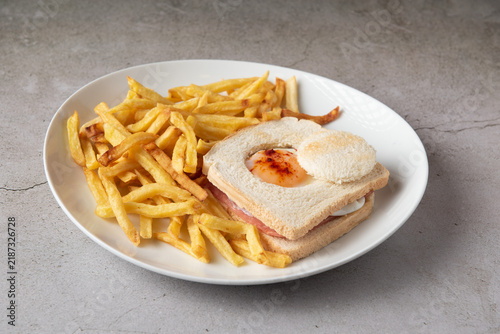 Baviera style sandwich with center fried egg and french fries