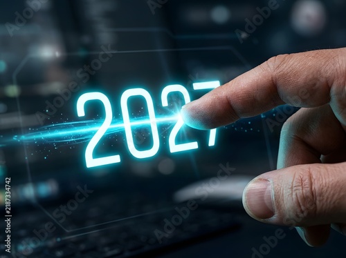 Futuristic interface with the year 2027 glowing in bright cyan numbers as a persons finger points towards it