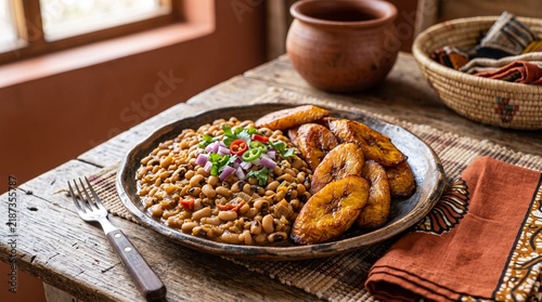 Delicious plate of traditional West African black-eyed peas and fried plantains, a hearty and flavorful meal