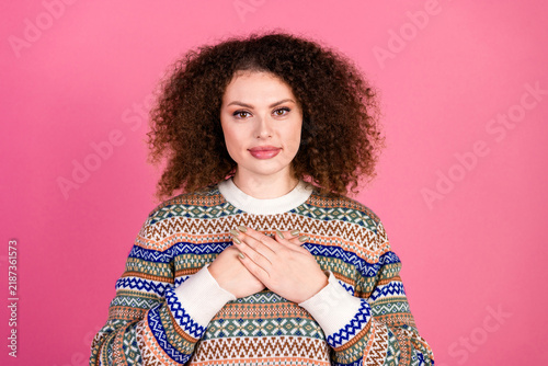 Canvastavla Young woman in patterned sweater expressing gratitude with hands over heart agai