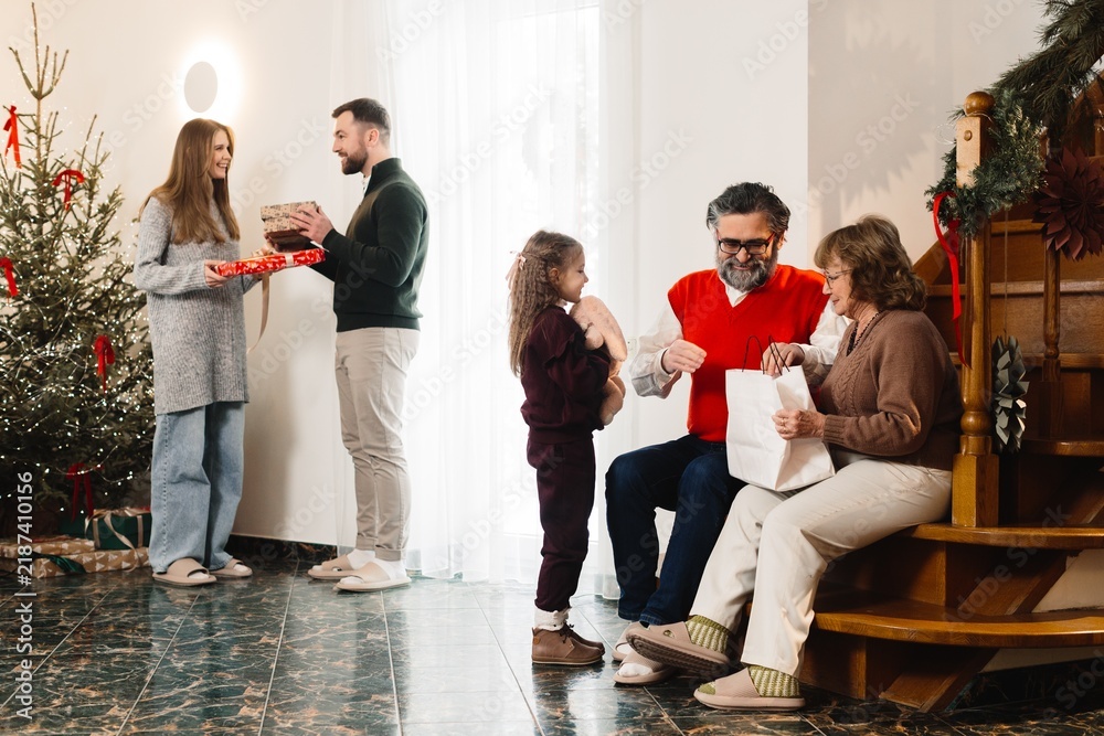 Fototapeta premium Family gathering celebrating christmas, exchanging presents