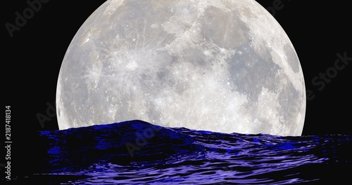 Moonrise over ocean surface with reflection on surface