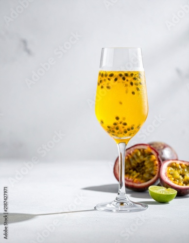 Elegant Passion Fruit Sparkling Beverage with Lime in Clear Glass and Soft Sunlight