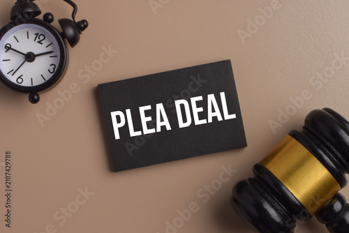 Fotografie Plea deal concept featuring a black card, gavel, and alarm clock, representing legal negotiation, criminal justice, court proceedings, agreements, and settlement