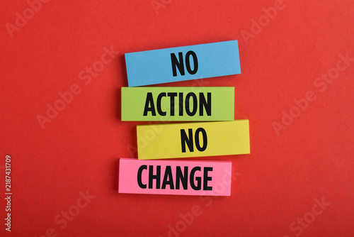 Bild auf Leinwand Colorful wooden blocks labeled No Action and No Change, symbolizing inaction, resistance, motivation, progress, decision making, and personal development