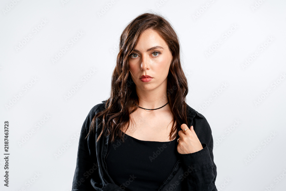 Fototapeta premium Serious brunette woman in black shirt studio portrait