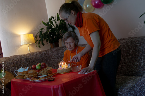 Photography Mother and daughter ignite candles on birthday cake