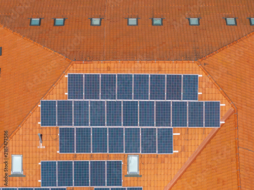 Aerial view of solar panels installed on a traditional orange terracotta tiled roof with skylights Vevchani, Vevcani Municipality, North Macedonia.