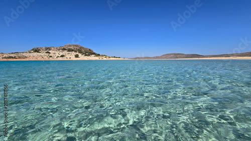 Fotografie Sparkling turquoise waters of Simos Beach in Elafonisos, Greece on a sunny day