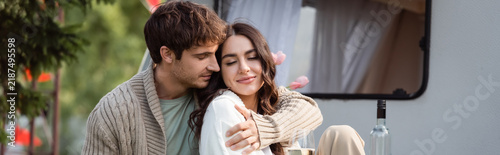 Принти на полотні Happy young couple enjoys cozy moments by their camping van during autumn trip,