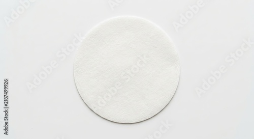 White circular wafer disc on white background.