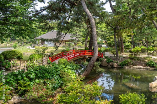 Red bridge in Shukkei-en Japanese garden in Hiroshima, Japan