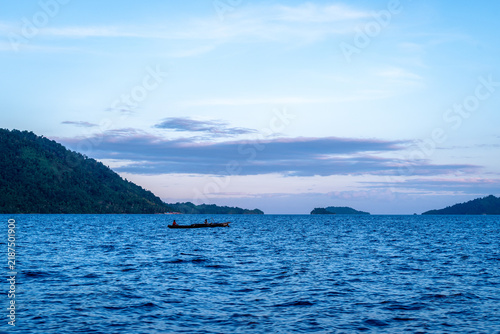 Foto Fishing canoe at sunset in the Togian Islands, Sulawesi, Indonesia