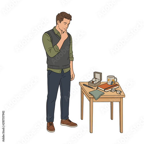 Thoughtful man in casual attire stands by a table with personal items a watch, pen, and mug, representing introspection, contemplation, and life's decisions