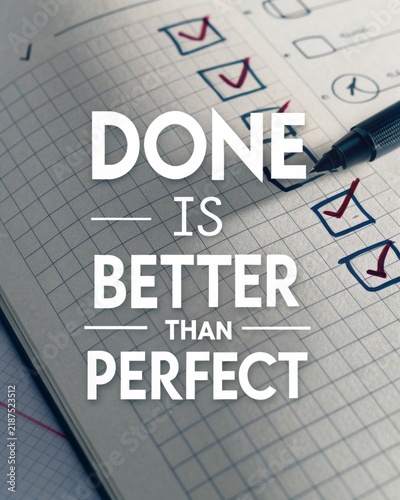 Motivational saying about productivity emphasizing that completion is preferable to perfection featuring a checklist and a pen resting on a notepad