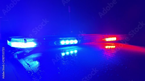Police lights flashing at night downtown at crime scene. The lights of the patrol car. Emergency assistance.