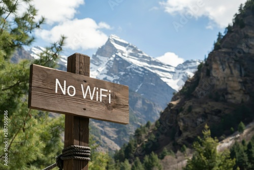 Wooden sign with no wifi text in front of a scenic mountain landscape