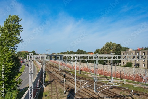 Quadro su tela Railway Tracks and Overhead Power Gantries under Clear Sky