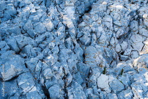 Abstract Blue Stone Wall Texture with Rough Granite and Marble Patterns, Cold Ice Blue and Gray Natural Rock Surface Background in Close-Up Macro Detail