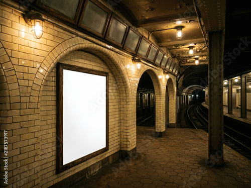 Vintage subway station platform with blank advertisement space and arched hallway